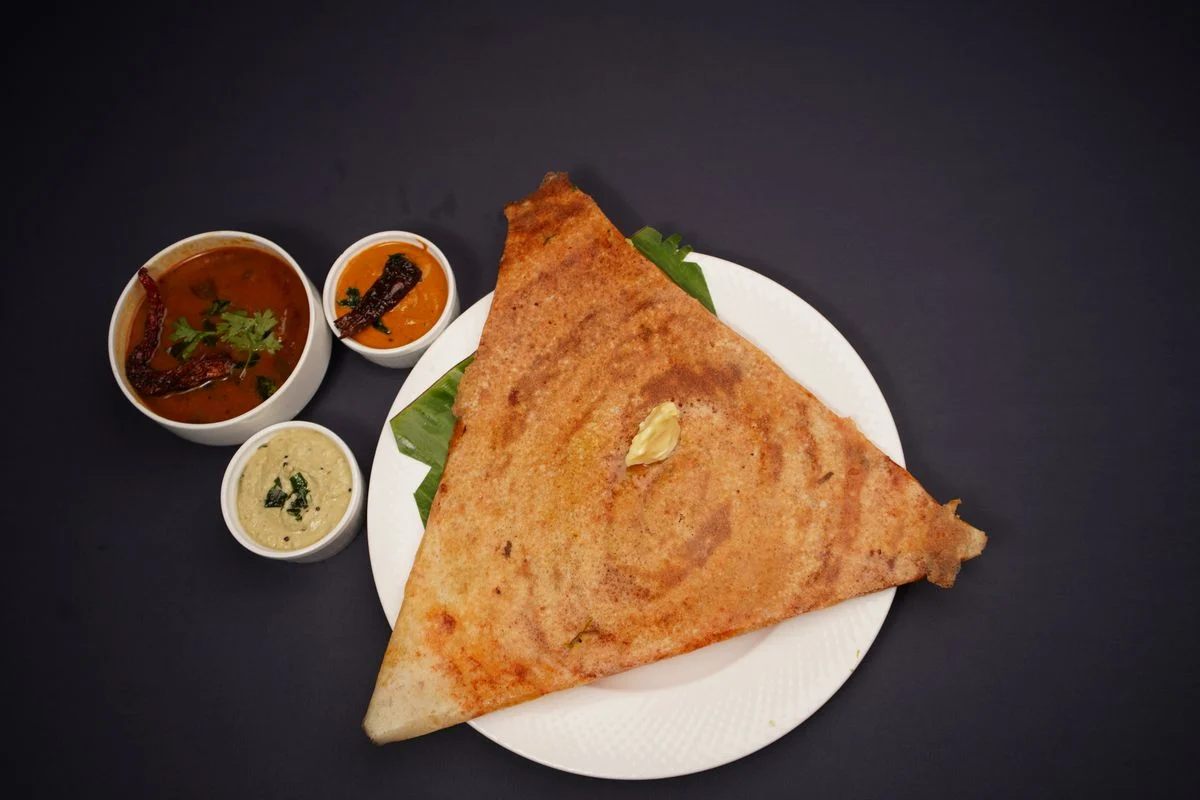Crisp dosa served with chutneys and sambar