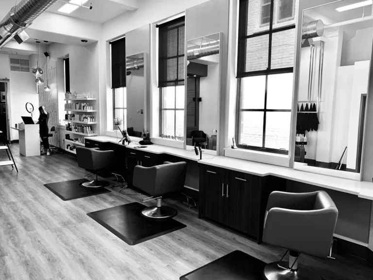 Bright minimalist salon interior with styling chairs