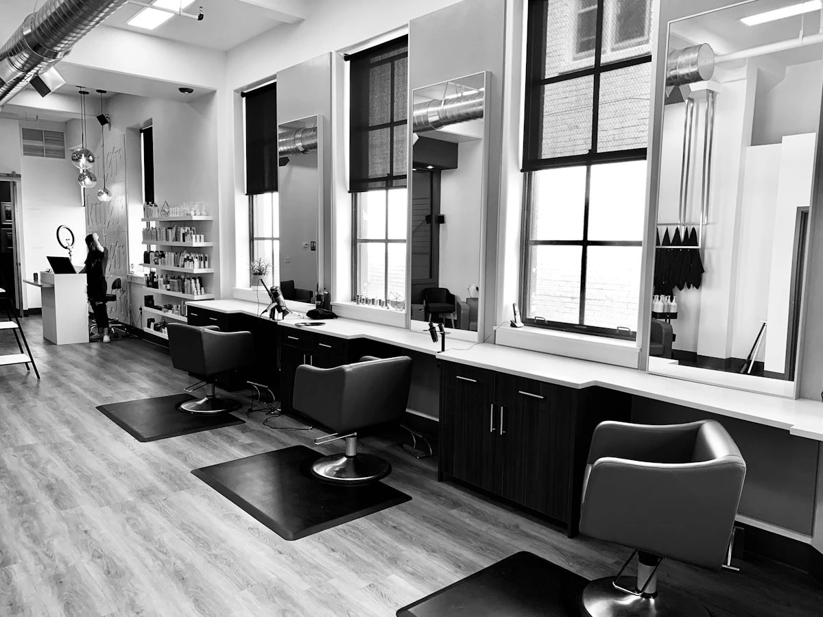 Bright minimalist salon interior with styling chairs