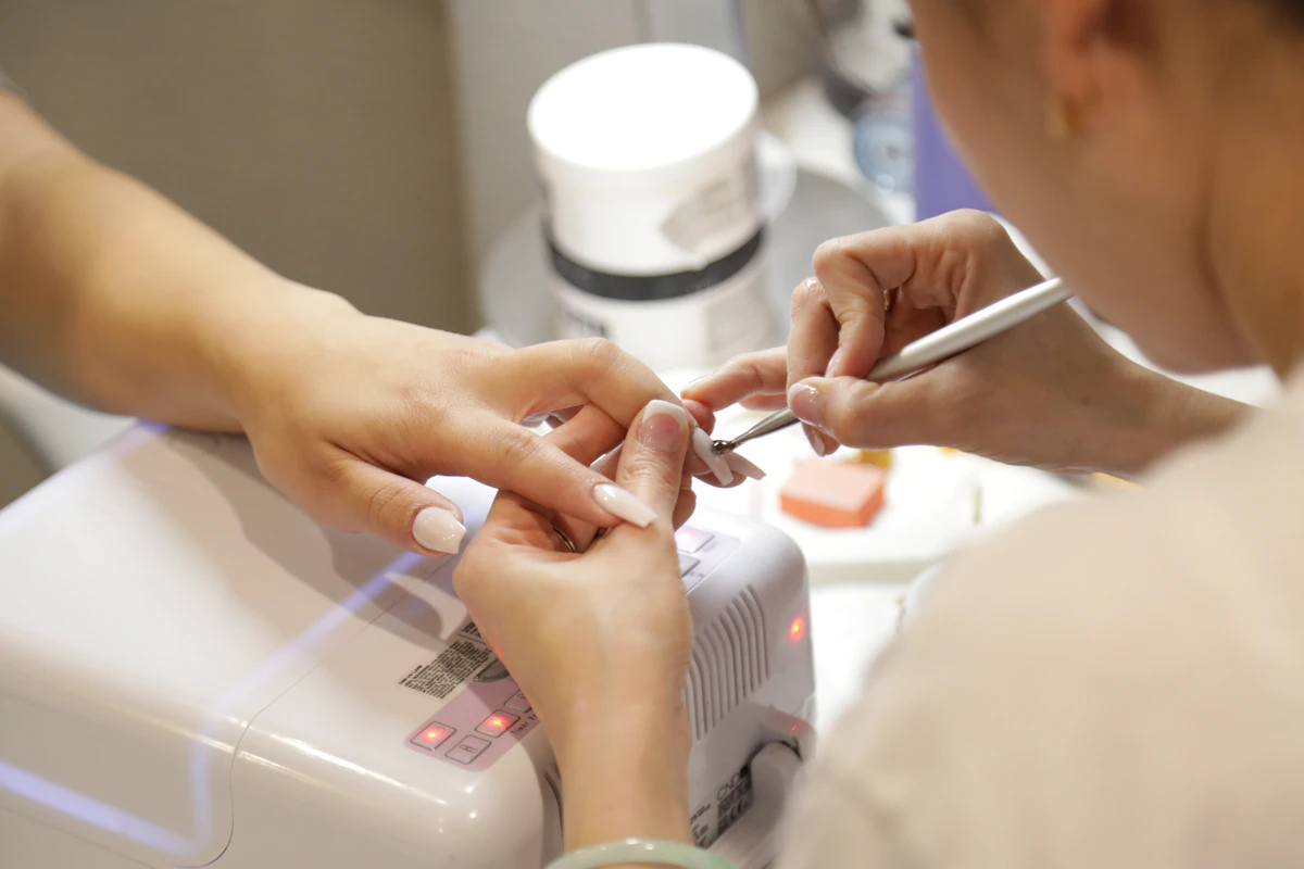 Nail technician giving a careful manicure